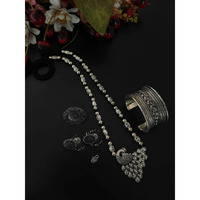 You can never go wrong with a statement oxidized necklace set. Beautifully ornated withfloral motifs, stones studded with dreamy white pearl drops, this unique necklace set willmake you fall in love with it instantly and is available in six different colours like red, green,black, dark blue, light blue, and multicolour. The gorgeous statement earrings add a bling toyour outfit. Pair it with your saree, low neck kurta, or lehenga and look stunning! It isnecessary to keep this product away from ha