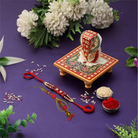 Purpledip Rakhi Hamper for Bhai-Bhabhi: Bhai Rakhi Bracelet. Bhabhi Rakhi (Lumba or Latkan), Roli Chawal Tika, Designer Marble Chowki Ganesha (rakhi1c)