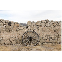 Wagon wheel against a stone fence at Hueco Tanks State Park, northwest of El Paso, TX-Paper Art-62"x42"