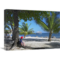 Tourist resting under palm trees on beach at Palmetto Bay, Roatan Island, Honduras-Canvas Art-24"x18"