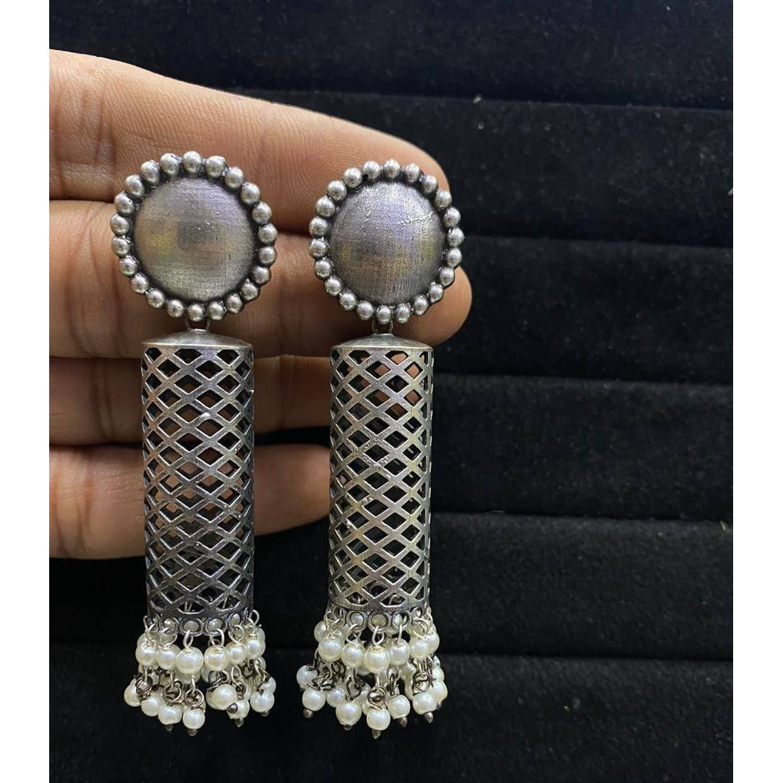 A striking pair of earrings inspired by ghungroos. Hoops with a bunch of playful ghungroos that add a fun element to the look. These Ghungroo Silver Oxidised Hoop Earrings spell elegant and effortless styling. Style this up with your favorite ethnics or pair them up with your casual outfits for a cheeky look!