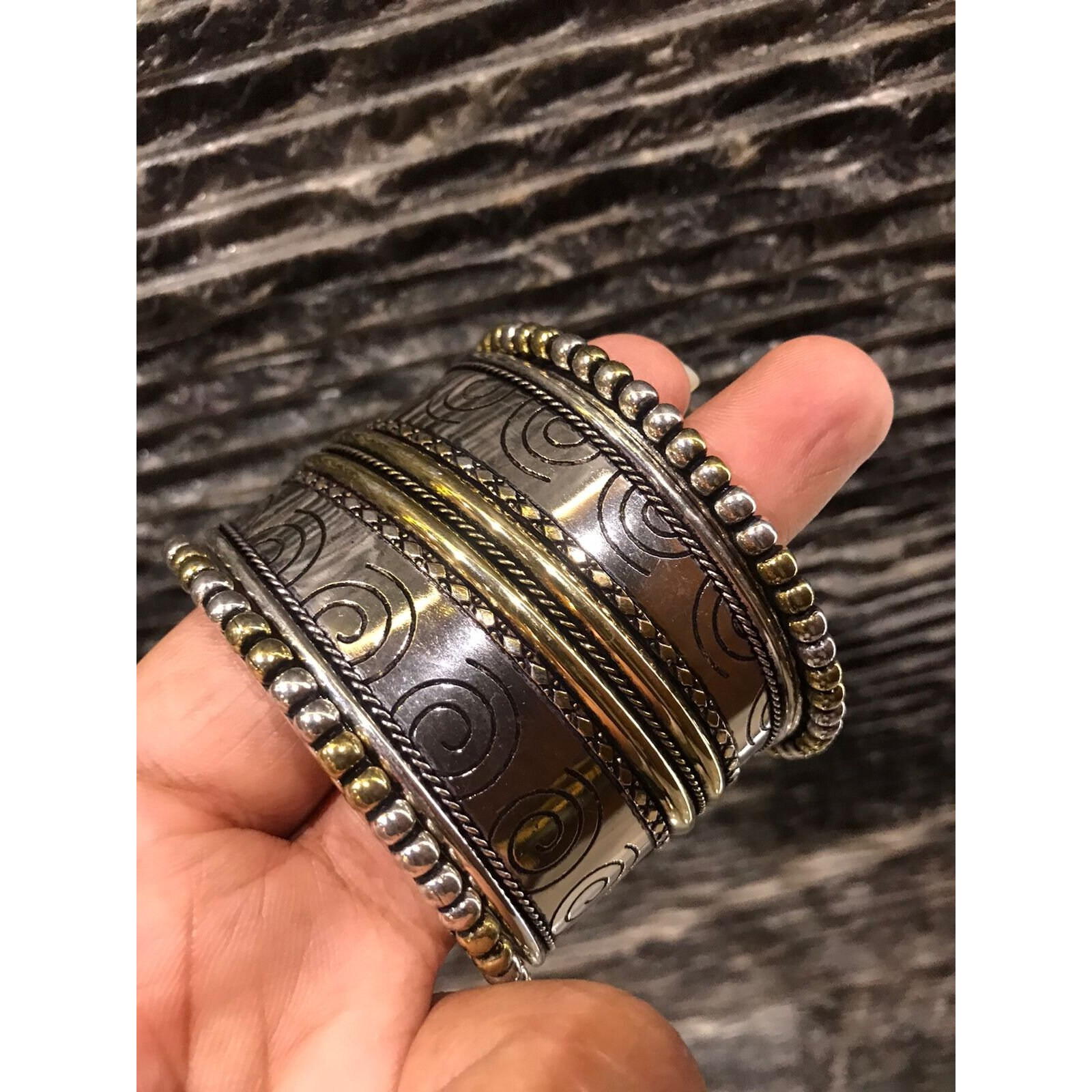 One of our favourites from our afghani collection, this gorgeous statement ring is one of a kind. Boasting of beautifully set raw cut mirror in a floral pattern, this ring is crafted in german silver and finished with oxidised silver plating. This beautiful piece is extremely versatile and can be paired with your Indian as well as well outfits.Note - The product is handmade and the mirrors are cut and pasted by hand, hence there might be certain irregularities in the finishing, which is not a de