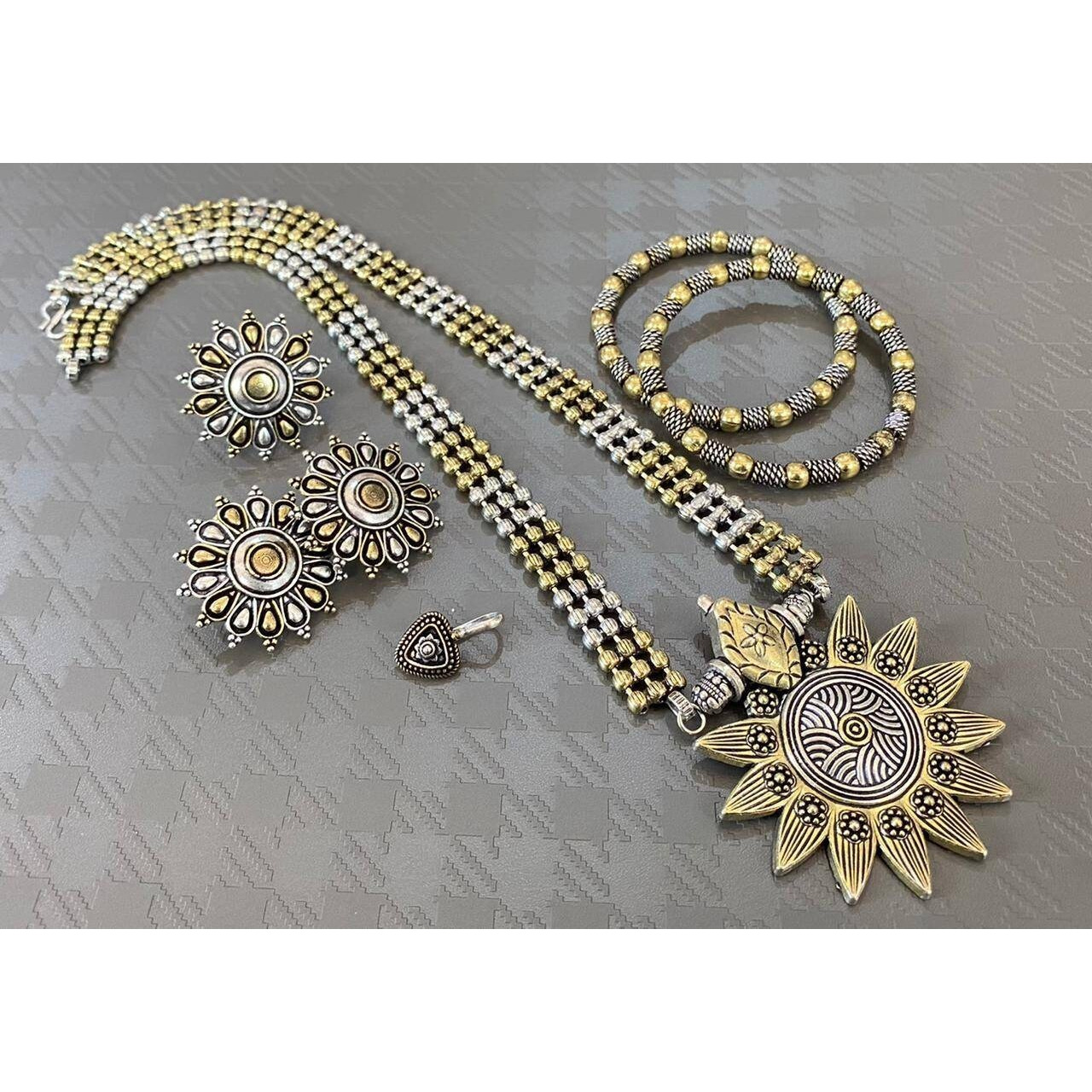 Impressively detailed and elaborate- this long necklace and earrings set with these beautiful and delicate petal motifs studded with stones are versatile enough to justify everyday or occasion dressing. Find your inner gypsy vibe and express with style these statement jewels.Wear together or separately.