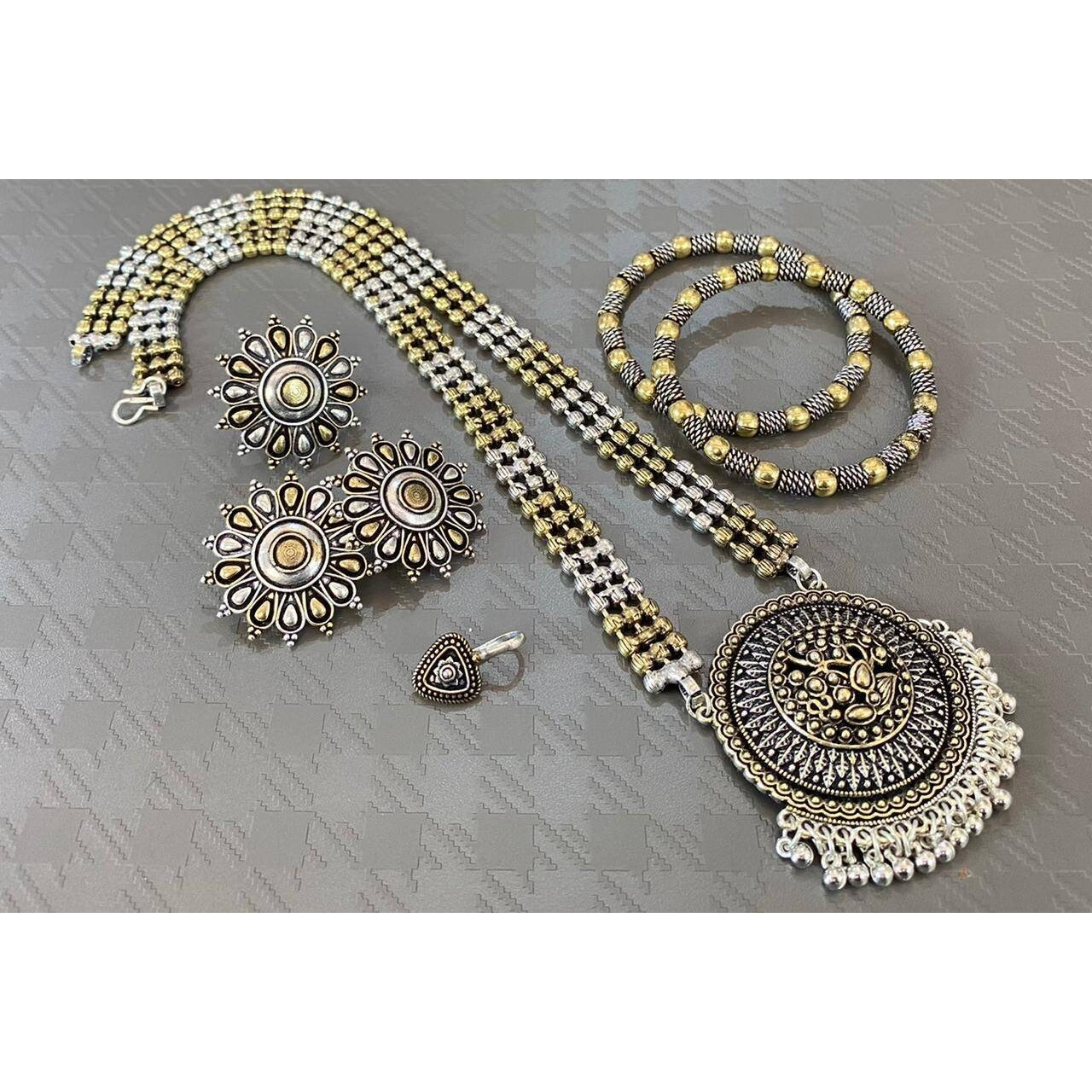 Impressively detailed and elaborate- this long necklace and earrings set with these beautiful and delicate petal motifs studded with stones are versatile enough to justify everyday or occasion dressing. Find your inner gypsy vibe and express with style these statement jewels.Wear together or separately.