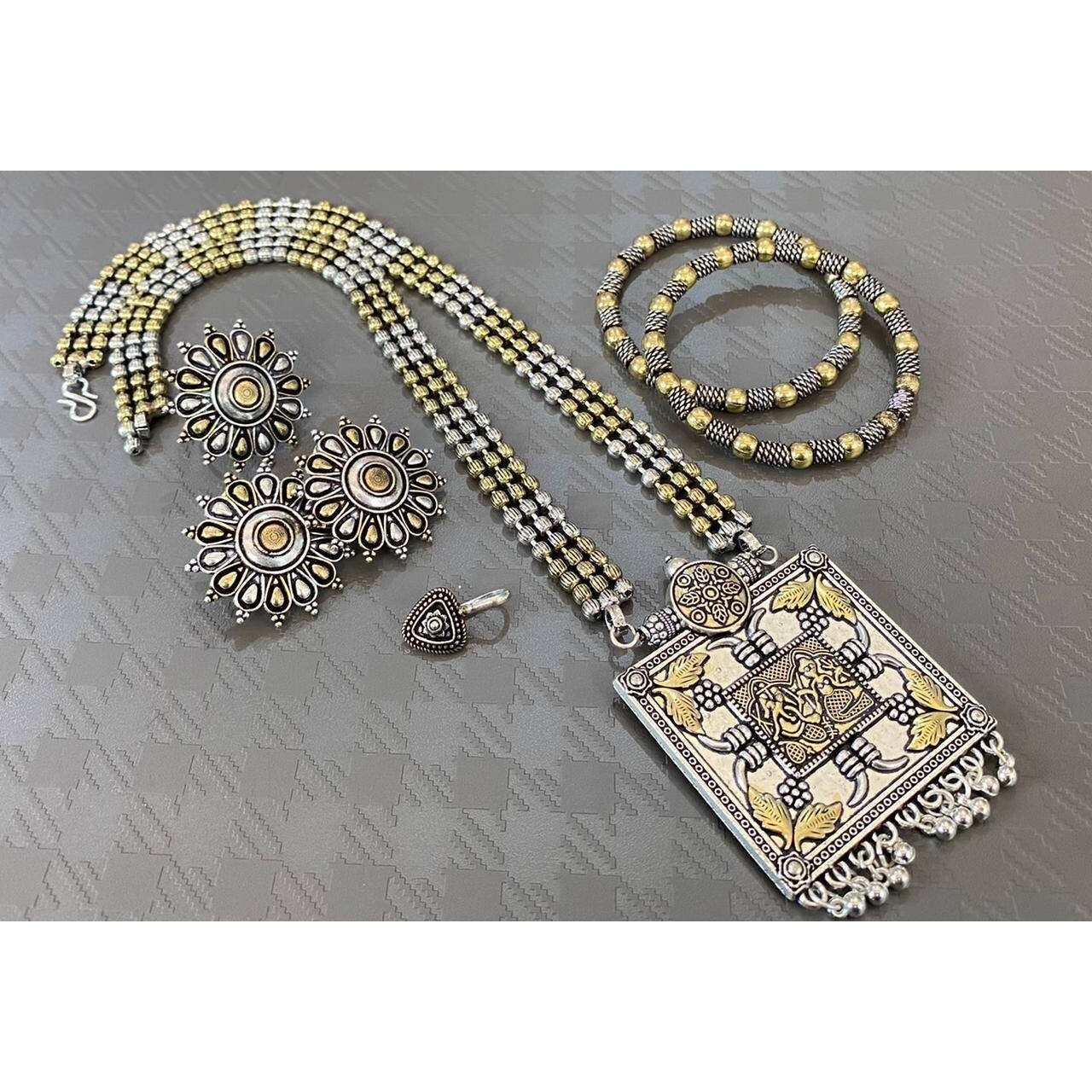 Impressively detailed and elaborate- this long necklace and earrings set with these beautiful and delicate petal motifs studded with stones are versatile enough to justify everyday or occasion dressing. Find your inner gypsy vibe and express with style these statement jewels.Wear together or separately.