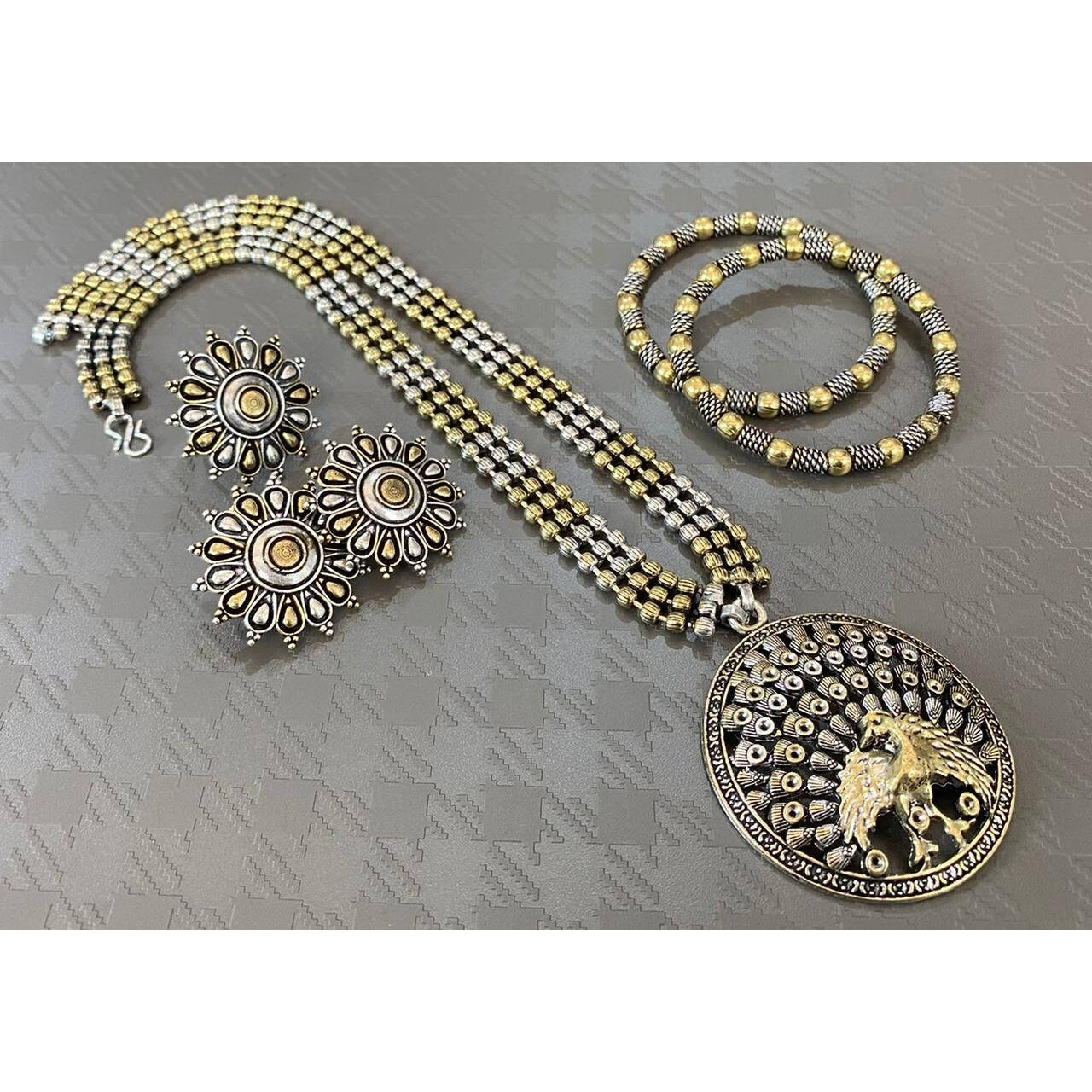 Impressively detailed and elaborate- this long necklace and earrings set with these beautiful and delicate petal motifs studded with stones are versatile enough to justify everyday or occasion dressing. Find your inner gypsy vibe and express with style these statement jewels.Wear together or separately.