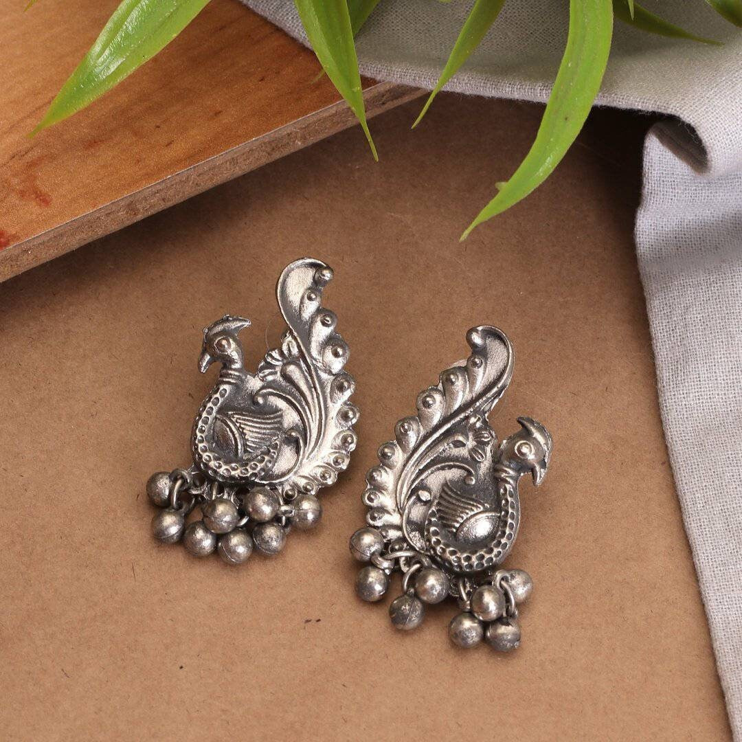 We can't get enough of earrings! These earrings feature the iconic Lord Ganesha design with Trishul and tiny pearl drops that surely reflect your lively personality. A pair of earrings that will awaken the jewelry lover in you. Festive styling goes easy with this pair of earrings. Style this up with your outfit for a rich look.