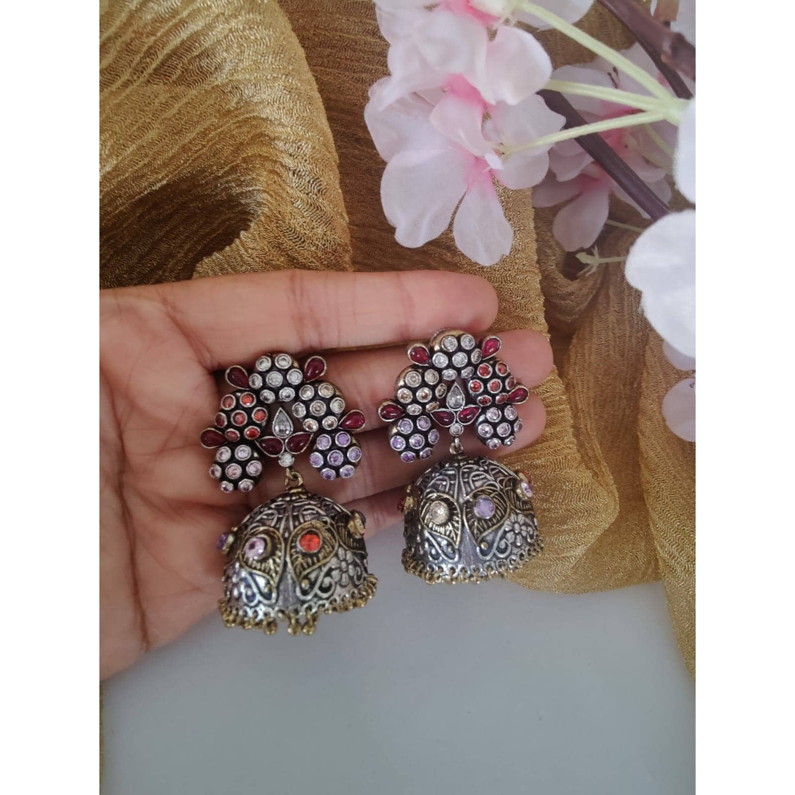 Silver oxidised earrings are an obsession for us and we fuel the obsession with a big bold version of the same recreated in these lovely earrings. Jhumkis remains an integral part of Indian dressing and will be adorned forever. This Antique Silver Jhumki Earrings will be a perfect accessory to complete your ethnic look this season. The beauty of this accessory lies in the intricate circular motifs. This pair of earrings will justify your white shirt and that Kurta and denim casual look.