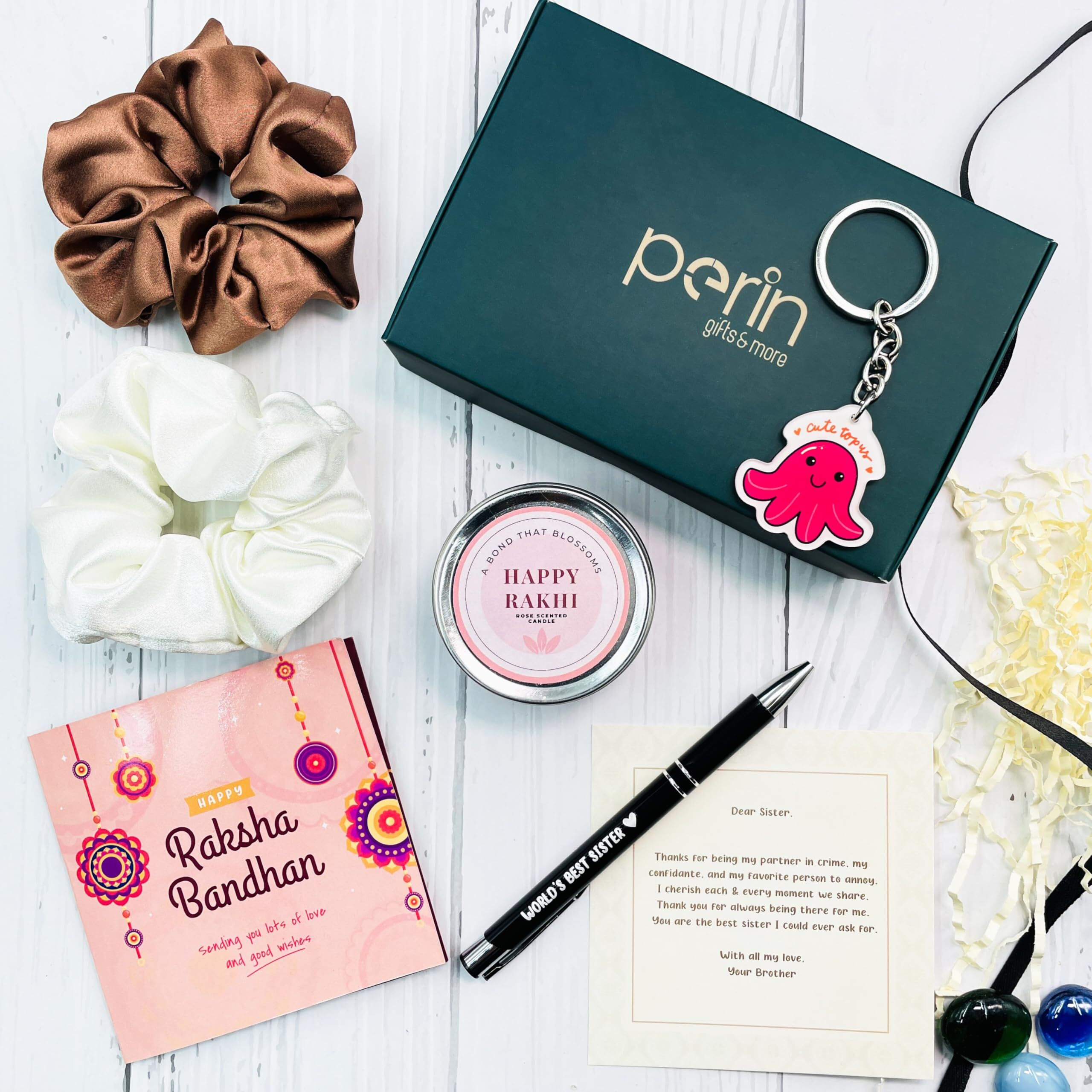 SINCE 7 STORE Rakhi Gift Hamper for Sister - Includes 6 products Metal Pen which says Worlds Best Sister, 2 Scrunchies, Keychain, Scented Jar Candle, and Heartfelt Note from Brother