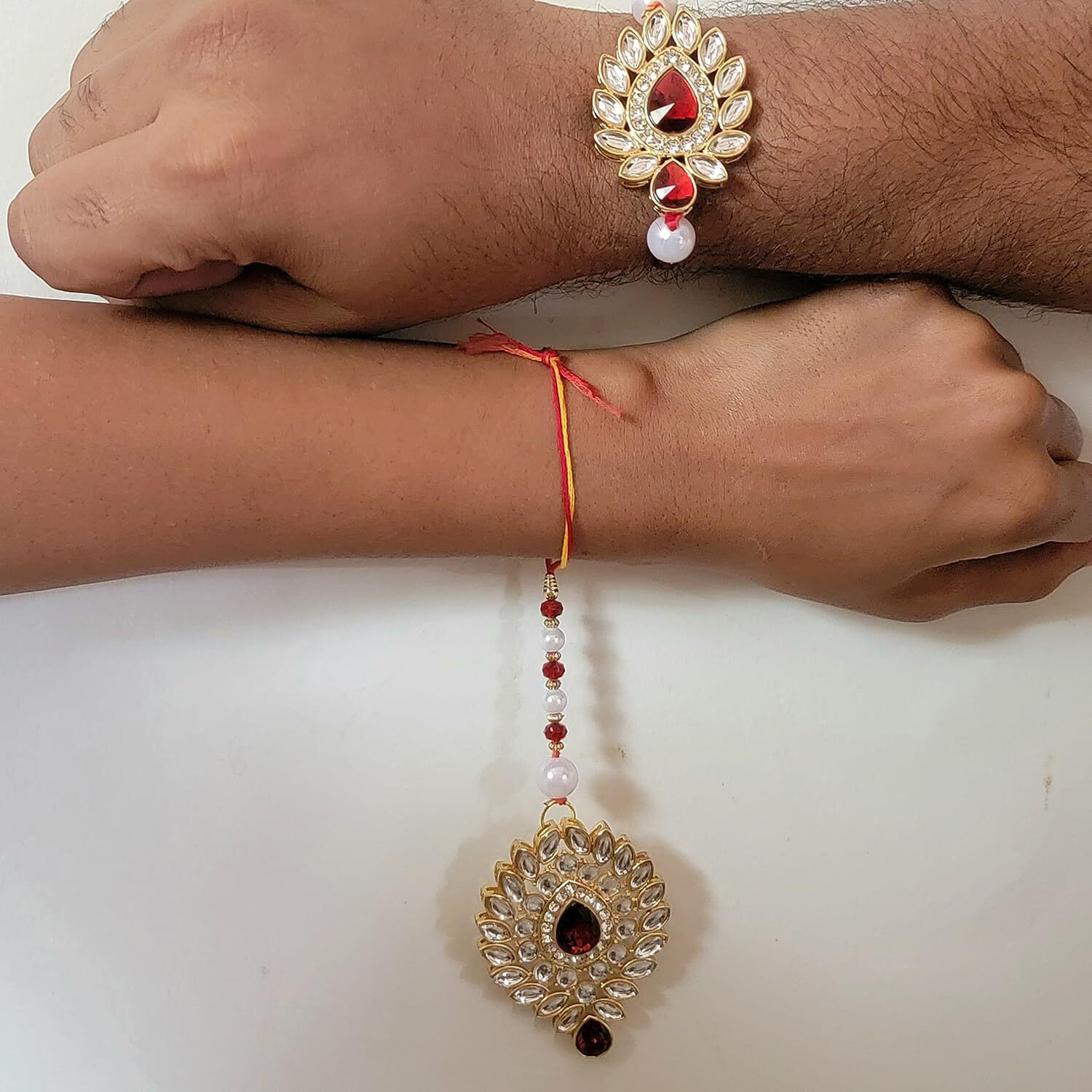 Mahi Gold Plated Red & White Crystals and Beads Leaf Shape Rakhi for Men and Women (RCLO1105435G)