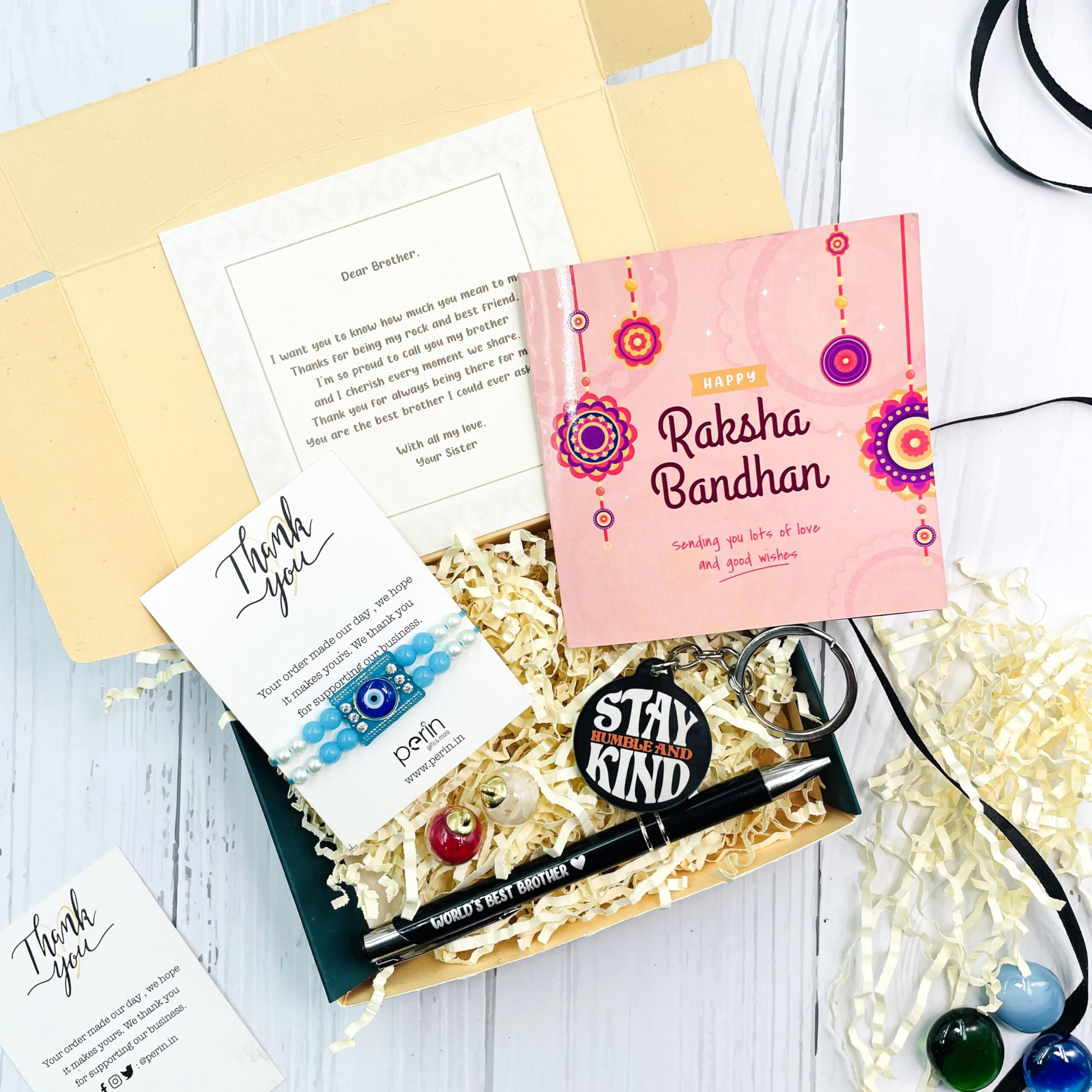 SINCE 7 STORE Rakhi Gift Hamper for Brother - Includes 6 Products Metal Pen which says Worlds Best Brother, Keychain, Rakhi, Set of Roli, Greeting Card & Heartfelt Note from Sister