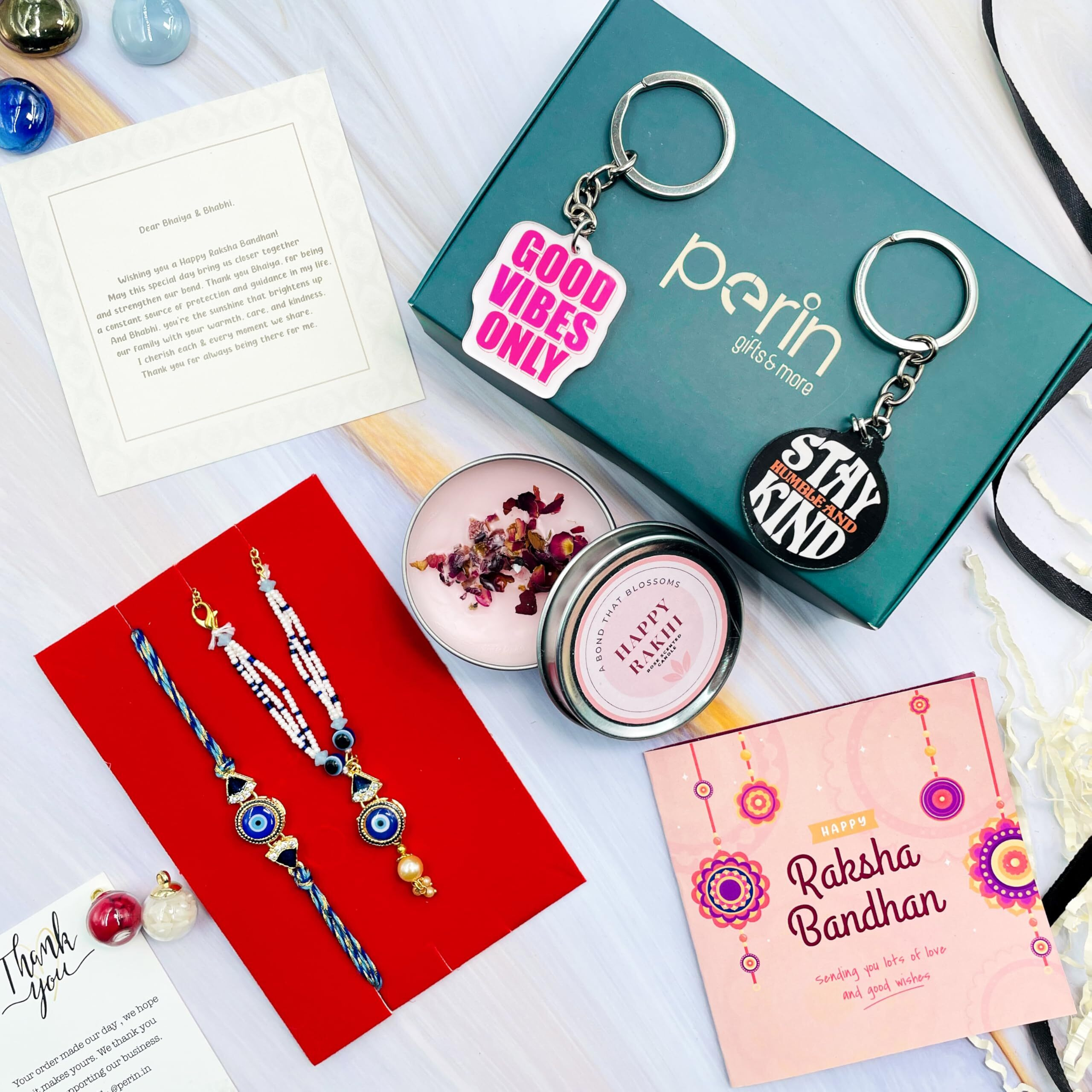 SINCE 7 STORE Rakhi Bhaiya & Bhabhi Gift Hamper - Includes 7 Products, Premium Pair Rakhi, 2 sets of Keychains, Set of Roli, Greeting Card & Heartfelt Note. Perfect Him & Her Gift Set