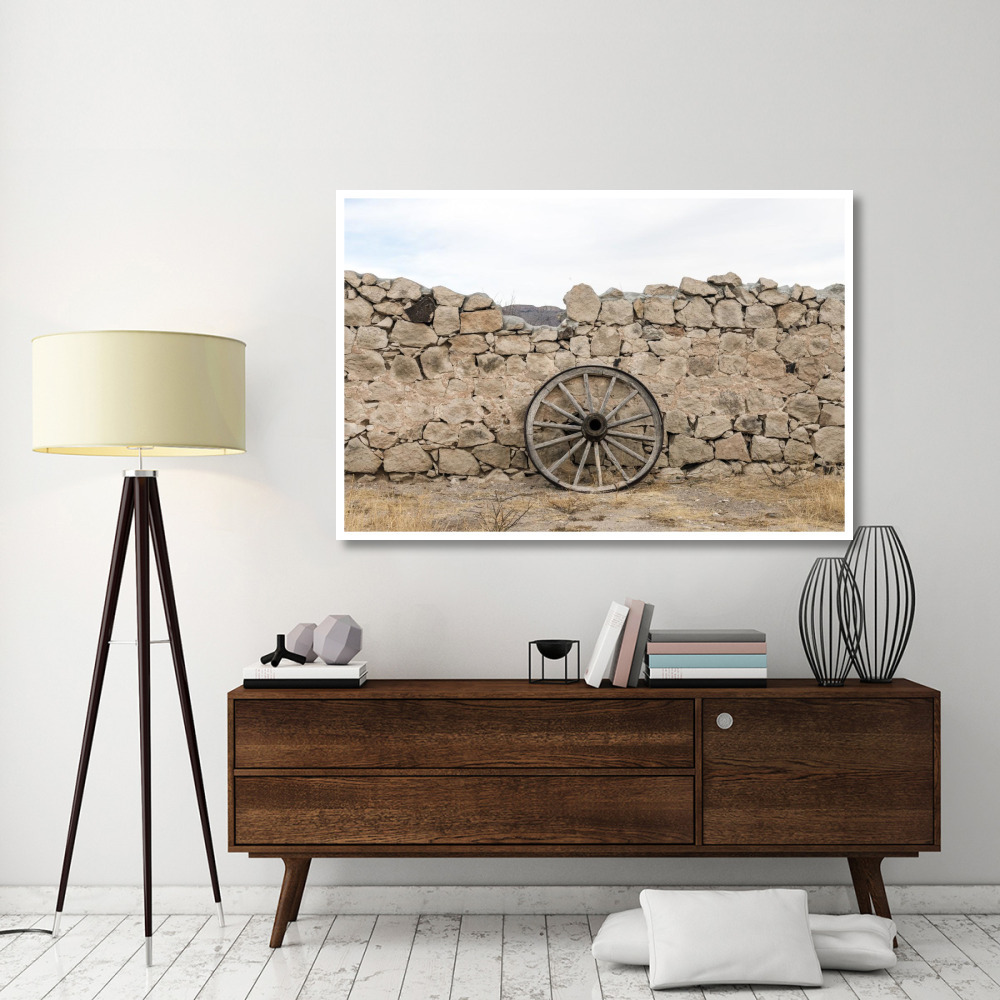 Wagon wheel against a stone fence at Hueco Tanks State Park, northwest of El Paso, TX-Paper Art-62&quotx42"